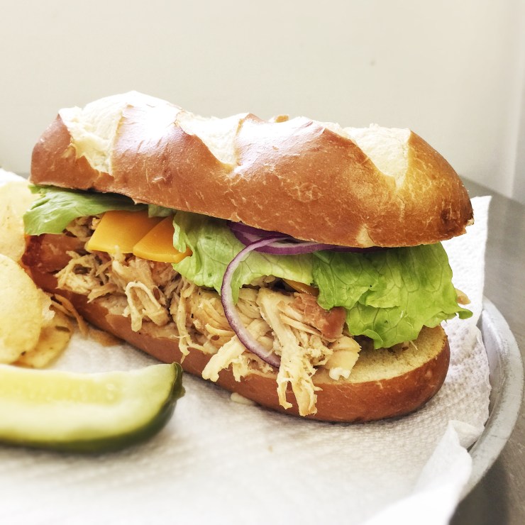 pulled chicken on pretzel roll